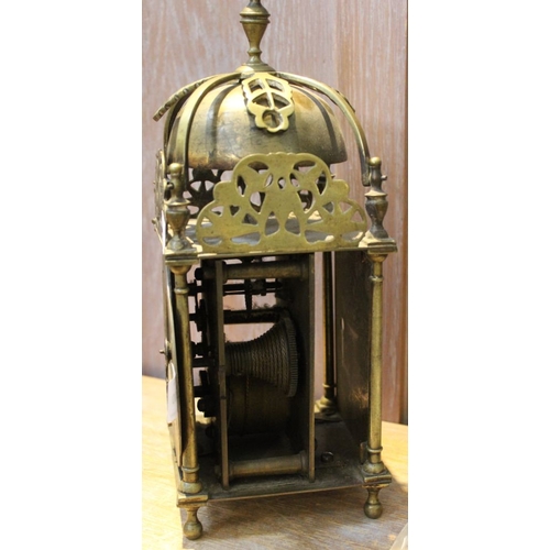 200 - A reproduction brass Lantern clock, fitted bell strike to top, silvered chapter ring with Roman nume... 