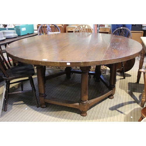 220 - A large 20th century oak round table on a substantial hexagonal base 167cm diam. 4.5cm depth of top ... 