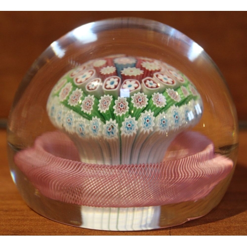 233 - A 19th century paperweight enclosing a Millefiori mushroom basket, surrounded with a twisted pink ba... 