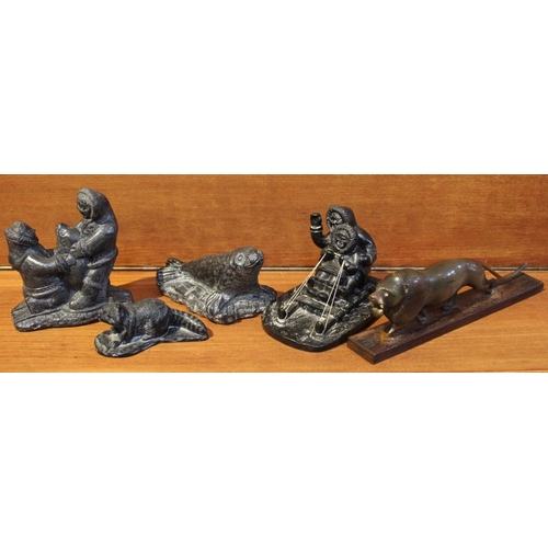 234 - A collection of four Inuit carved figures & a carved horn lion