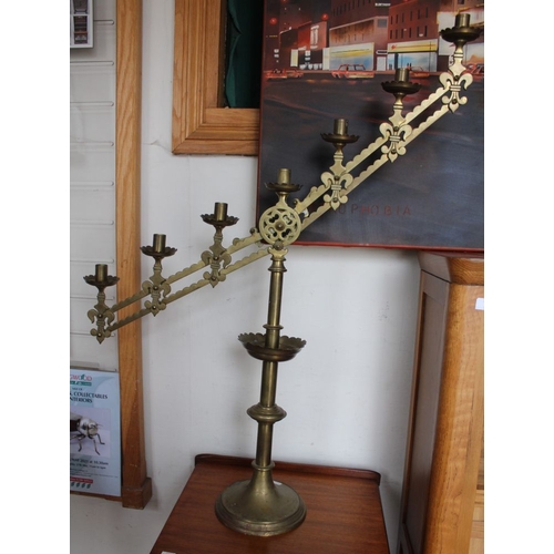 379 - A pair of brass ecclesiastical candelabras with mechanical adjustment in the gothic style