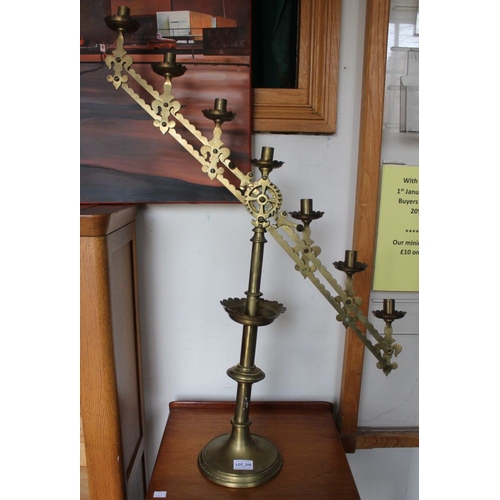 379 - A pair of brass ecclesiastical candelabras with mechanical adjustment in the gothic style