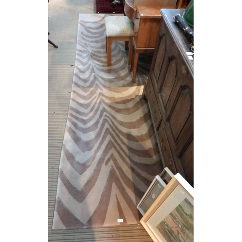 392 - A large modern brown and beige ground stripe effect floor rug, 278 x 365 cm