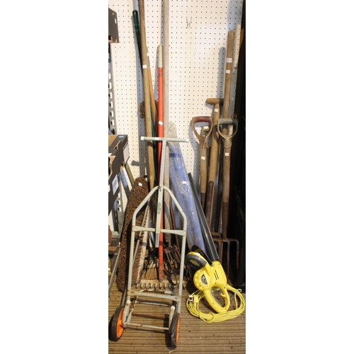 48 - A wide selection of garden tools including an electric hedge trimmer, forks, rake etc