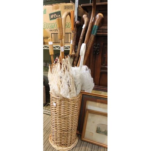 90 - A collection nine of old walking sticks and parasols in wicker stand