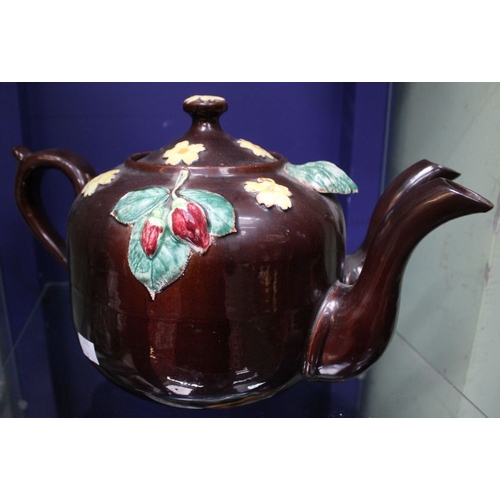 153 - A late Victorian treacle glazed terracotta double pouring teapot, applied and painted floral decorat... 