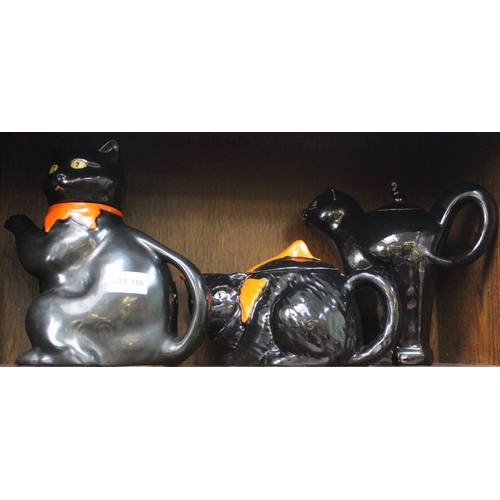 159 - Three black cat ceramic teapots, one with arched back, two with orange bows about their necks (3)