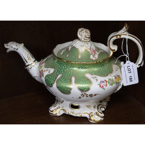 180 - A 19th century china teapot, gilded green with floral decoration