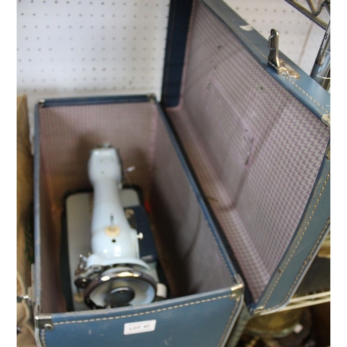 274 - A Jones hand operated sewing machine in blue carry case