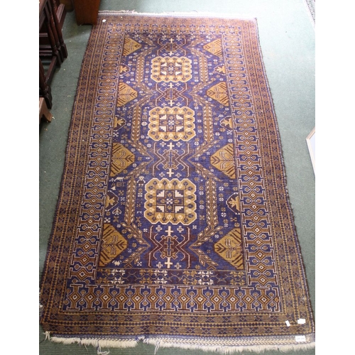 276 - A large floor rug, blue & brown based geometric pattern, approx 220cm x 110cm