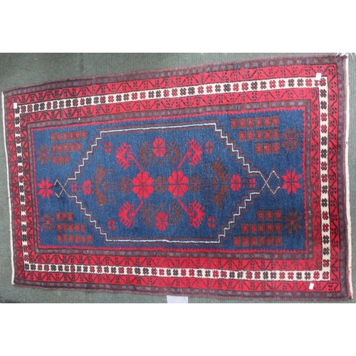 279 - A small hearth rug, blue & red ground geometric pattern, 135cm x 84cm