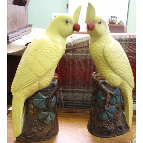 329 - A pair of Chinese ceramic yellow glazed Cockatoo on branch bases, impressed marks to base 36cm high