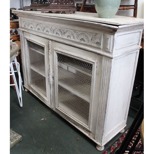 359 - A white painted sideboard with mesh doors, in an overall distressed condition