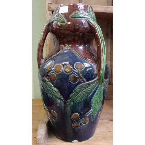 59 - A glazed pottery vase in the manner of Christopher Dresser, having three sprig handles, incised frui... 