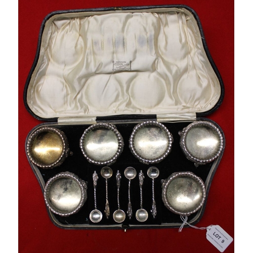 9 - A Victorian cased set of six silver salts, embossed floral decoration, together with six apostle ter... 