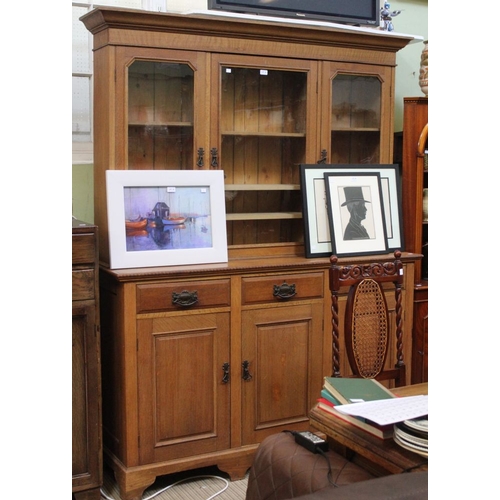 28 - An early 20th century oak dresser with three in-line drawers over cupboard base. Three door glazed s... 