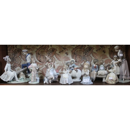 35 - A shelf containing a selection of Lladro and Nao porcelain figurines (9)