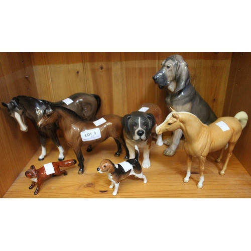 5 - A shelf containing a selection of ceramic animal figurines including five Beswick examples