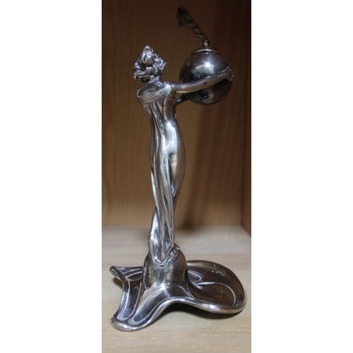 37 - A WMF design Art Nouveau plated metal oil lamp in the form of a Classically draped lady, supporting ... 