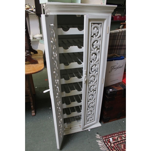 15 - An ornately carved twin doors, wine storage cupboard