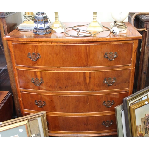 28 - A veneered bow front chest of four drawers