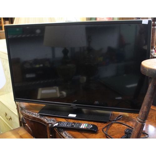 46 - A Hitachi television with remote control