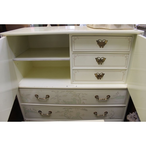 53 - A cream ground decorated compactum, two double doors with internal doors and three drawers to the ba... 