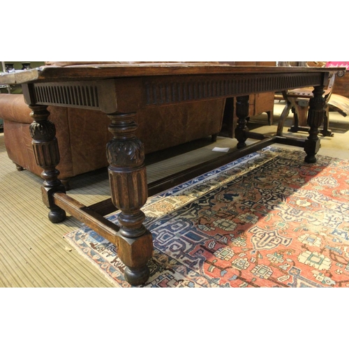 131 - An oak Elizabethan design refectory table, raised on carved cup and cover supports, united by stretc... 