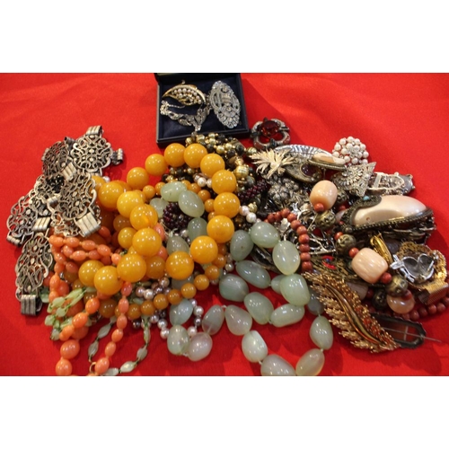 15 - A quantity of costume jewellery, to include beads, a belt, brooches, marcasite, etc contained in two... 