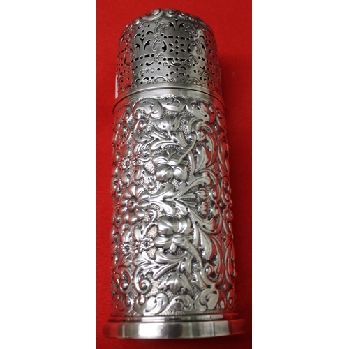 18 - A late Victorian silver sugar caster, cylindrical form, repoussé decoration, base with gilded interi... 