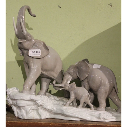 238 - Lladro figure of two Indian children riding an elephant, together with a Lladro elephant family, a/f