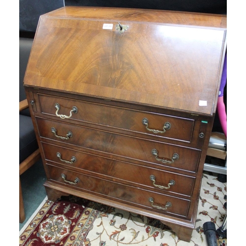 276 - A reproduction fall front bureau with fitted interior over four drawers with key