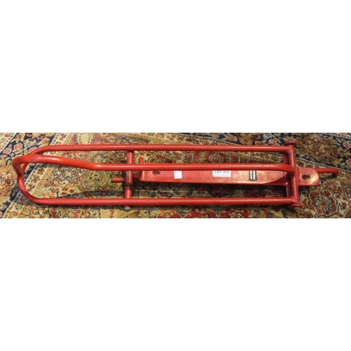 148 - A red metal wall mounted saddle rack by 