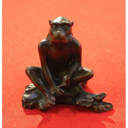 28 - A Japanese bronze seated monkey figure, see inscription character marks to base 5.5cm high