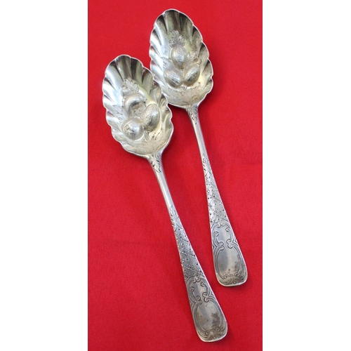 3 - A pair of early George lll silver berry spoons, embossed bowls with chased handles, London 1764, com... 