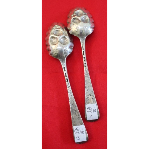 3 - A pair of early George lll silver berry spoons, embossed bowls with chased handles, London 1764, com... 