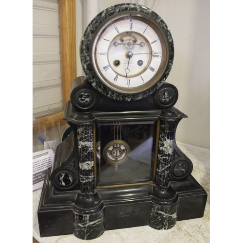 39 - A late 19th century black slate & marble mantle clock, the white enamel dial with Roman numerals, ha... 