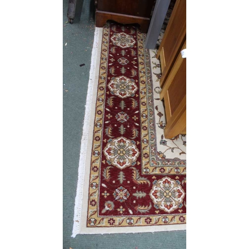 410 - A large red & cream ground geometric patterned floor rug, approx. 195cm x 300cm