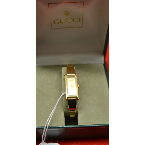 314 - Ladies Gucci gold plated bangle watch in original box with paperwork