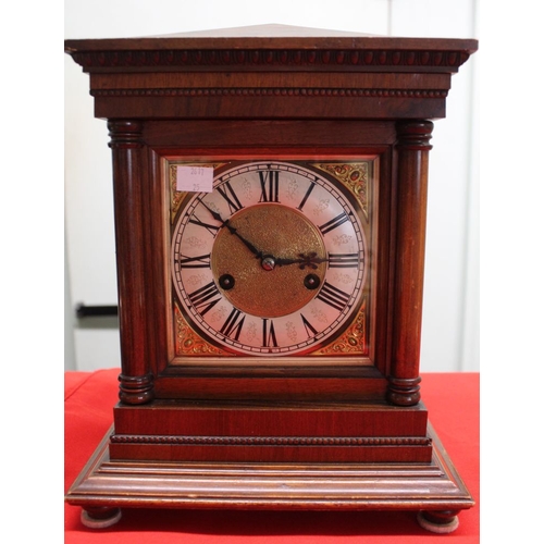 353 - A mahogany cased mantle clock, architectural form case, having roman numerals with 14 day chiming mo... 