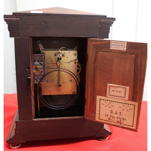 353 - A mahogany cased mantle clock, architectural form case, having roman numerals with 14 day chiming mo... 