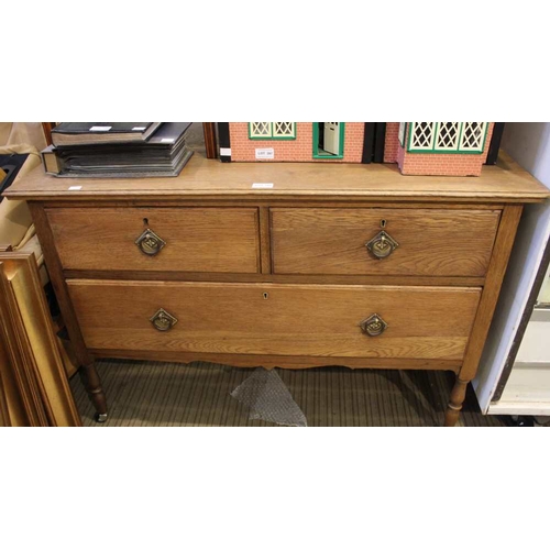 395 - An oak chest of two short over one long drawer with ring handles on turned supports, 105cm wide