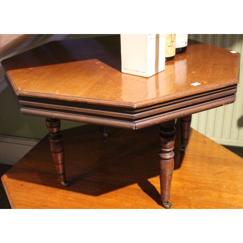 212 - A mahogany octagonal occasional/coffee table on turned supports with castors