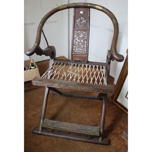 267 - A pair of Chinese hunting chairs, possibly Huanghuali with metal mounts, having horseshoe or Ox bow ... 