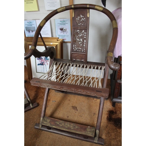 267 - A pair of Chinese hunting chairs, possibly Huanghuali with metal mounts, having horseshoe or Ox bow ... 