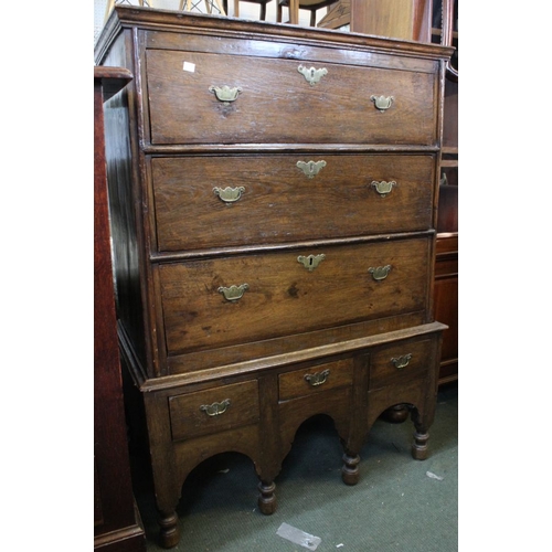 298 - A George III oak chest on stand brass handles. The top with three long drawers upon arcaded stand fi... 