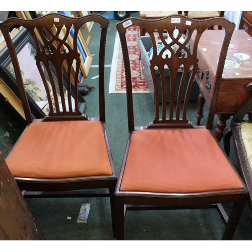 303 - A pair of splat back dining chairs with salmon pink drop in seat pads