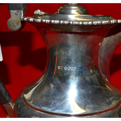 31 - Emile Viner, a Georgian design silver hot water pot, having hinged lid, raised on cast claw feet, Sh... 