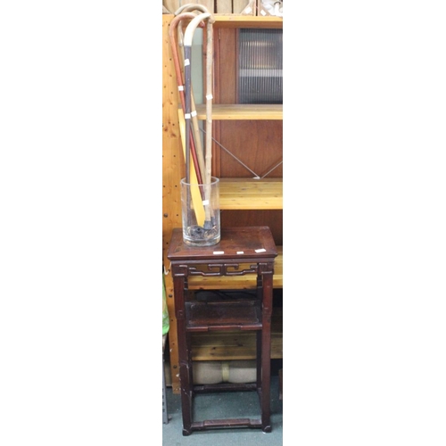 314 - An Oriental inspired hardwood plant stand with undertier, together with a selection of walking stick... 