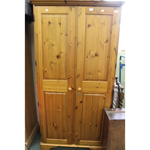 323 - A freestanding two door pine wardrobe